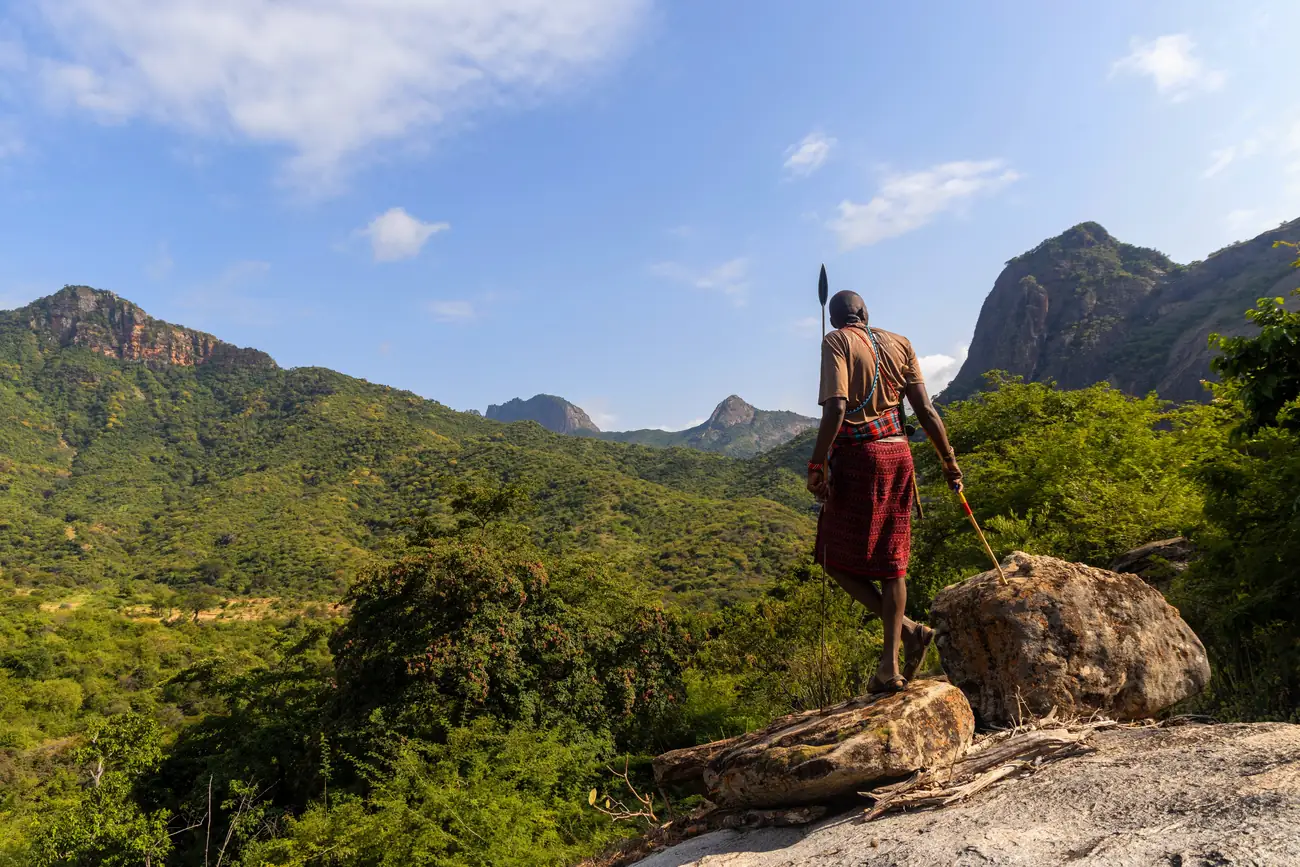A Samburu tracker reading the ground on a walking safari